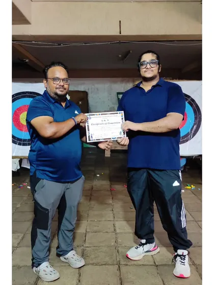 Presenting a certificate to another successful student. It's rewarding to see their dedication pay off.