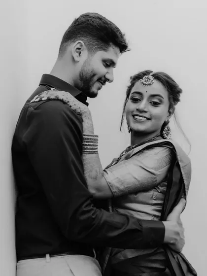 A classic black and white portrait of a couple in a happy embrace. The simplicity of monochrome enhances their joyful expressions and genuine connection.
