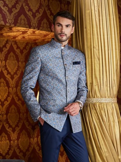 This blue patterned bandhgala, paired with royal blue trousers, exudes royalty. The intricate weave of the fabric makes it a standout piece for any formal event.