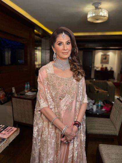 A full view of this ethereal and bronzed look. The makeup is flawless and glowing, perfectly complementing her Anamika Khanna outfit.