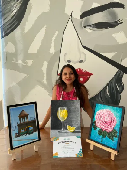 This student's final projects from the acrylics course include a textured rose, a still life, and a cityscape, showcasing her versatile skills.
