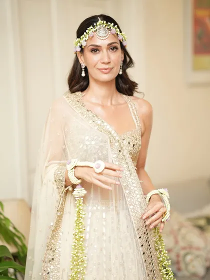 Natasha's Mehendi look was all about fresh, natural beauty. The makeup is light enough to feel comfortable but polished enough to look perfect in photos, capturing the happy and relaxed vibe of the ceremony.