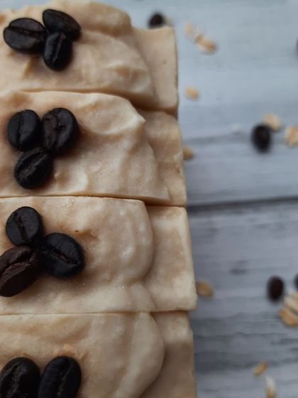A close-up of my Scrubby Coffee soap, topped with real coffee beans. I use ground coffee for a gentle exfoliation and oat milk to ensure the bar is creamy and moisturizing, perfect for a morning pick-me-up.