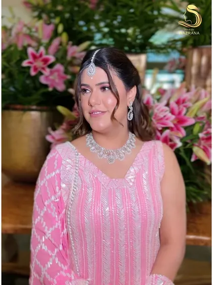 My client looking elegant in her Manish Malhotra outfit, with a pearl-adorned hairstyle to match.