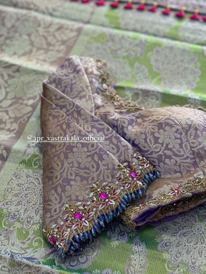 A close-up of the sleeve cuff with vibrant stone work.