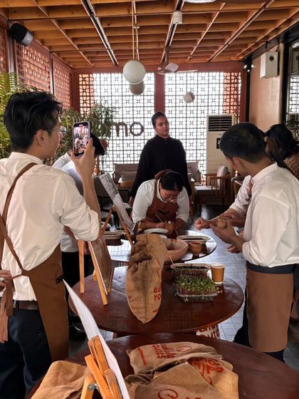 A group learning the techniques of sowing microgreen seeds. The concentration and engagement show how captivating the process can be.