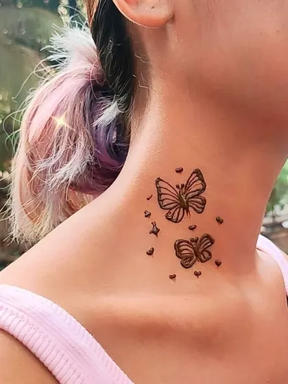 A delicate butterfly tattoo on the neck, a very popular and modern request.