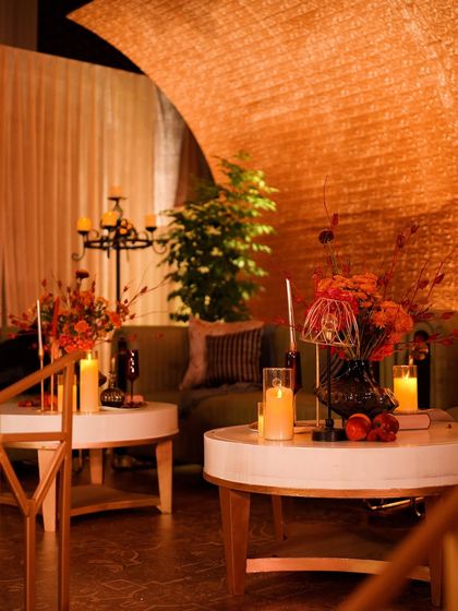 A lounge area from "The Secret Waltz" speakeasy, with warm, moody lighting and rich textures.