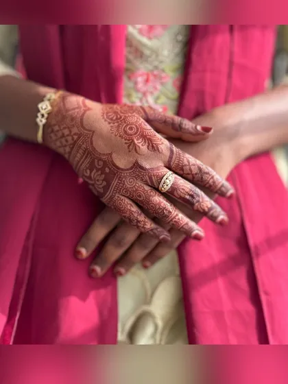 A close-up shot focusing on the deep color of the stain. You can see the intricate details of the design on the fingers and back of the hand.
