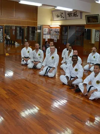 Here, a group of senior practitioners and I listen to the teachings of Grand Master Zenpo Shimabukuro in his dojo. Learning directly from the head of our style is an invaluable experience.