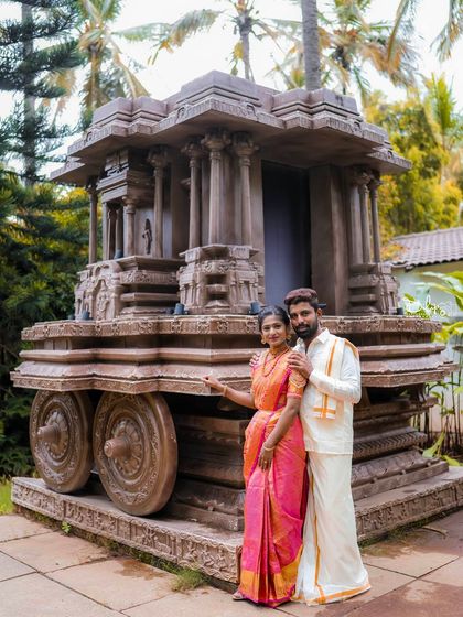 A classic portrait of a couple in traditional attire by our Hampi stone chariot replica.