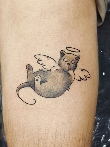 The finished angel cat tattoo, with soft shading to give it dimension.