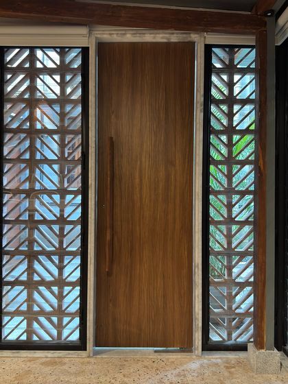 An interior view of the main door of the extension, flanked by the jali screens. This shot highlights the connection between the indoor and outdoor spaces, a key feature of our design.