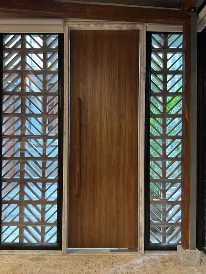 An interior view of the main door of the extension, flanked by the jali screens. This shot highlights the connection between the indoor and outdoor spaces, a key feature of our design.