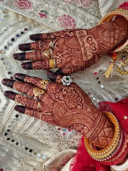 A wedding hashtag is a great personal touch to add to your bridal henna. This design features the couple's hashtag, #RumaNash, elegantly written into the palm.