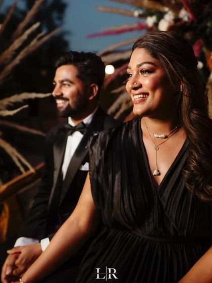 A candid moment of the couple during their evening celebration. The backdrop we designed with pampas grass and a rich maroon fabric created a warm, rustic, and elegant setting for their photos.