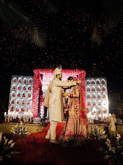 The exchange of garlands, a symbol of acceptance and love. I ensure this moment is highlighted with dramatic lighting and effects.