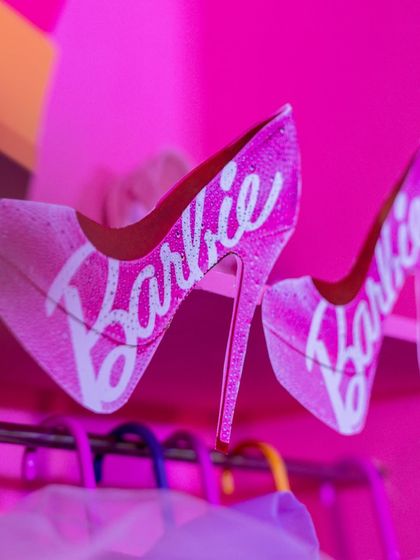 A close-up of iconic Barbie high heels used as part of the glamorous party decor.