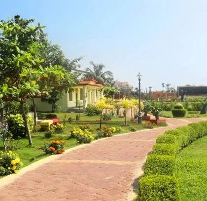 A beautifully landscaped park with winding brick pathways, neatly trimmed hedges, and colorful flower beds. This is an example of our public space design, focusing on creating enjoyable and accessible green areas.