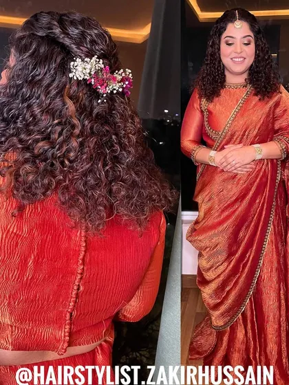 I love working with naturally curly hair to enhance its beauty. This half-up style features a simple twist and is adorned with fresh flowers, celebrating the hair's natural texture.