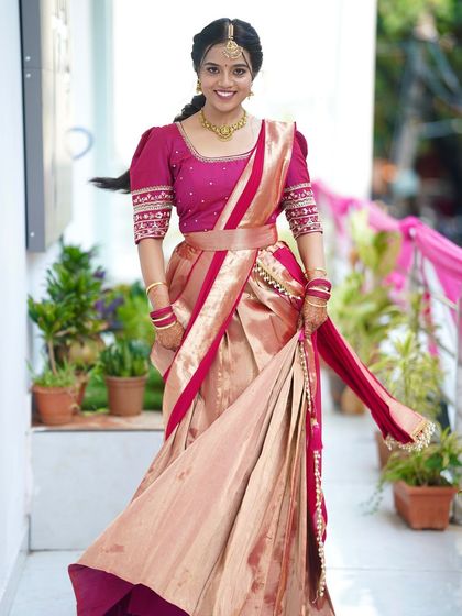 A dynamic shot of a bride in her half-saree. The makeup is designed to be photogenic and stay in place, even with movement.