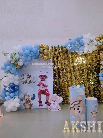 A teddy bear themed first birthday with a gold sequin wall and personalized backdrop.