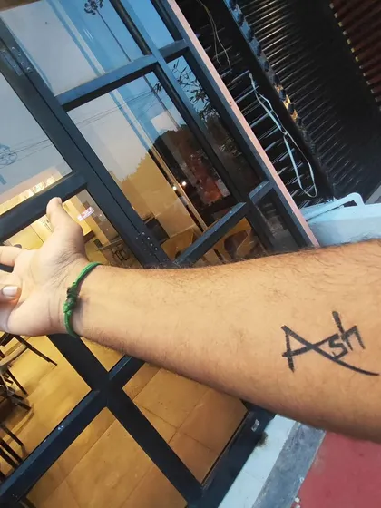 A simple and stylish custom name tattoo. I can create a unique font design like this one for you in just a minute. It's a popular choice for people who want to try out a name design before committing to a permanent one.
