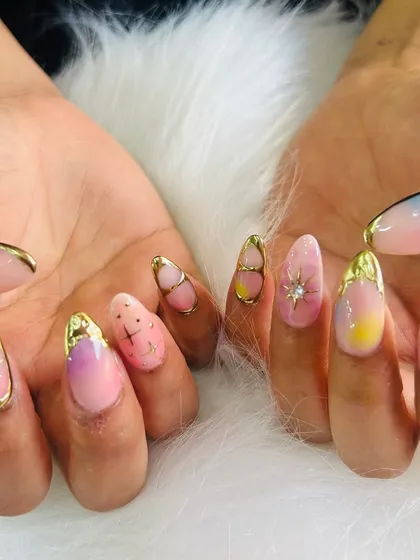 A colorful and festive set with a pastel ombré base, gold chrome accents, and sparkling starbursts.