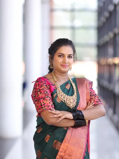A confident pose, showing off the beautiful details of the necklace.