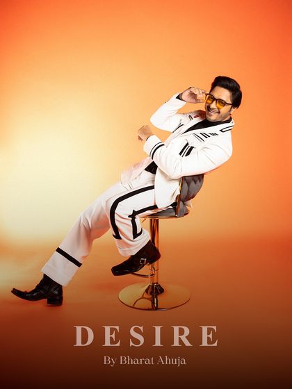 Dripping in charisma, tailored to perfection. This relaxed, seated pose captures the playful and confident spirit of the striped suit.