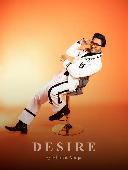Dripping in charisma, tailored to perfection. This relaxed, seated pose captures the playful and confident spirit of the striped suit.