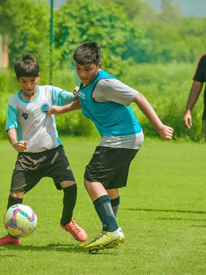 Two players challenge for the ball near the corner flag, a moment of intense competition.