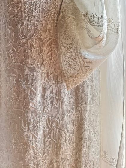 A detail shot focusing on the sleeve and side panel, highlighting the fine 'jaali' work and delicate floral patterns.