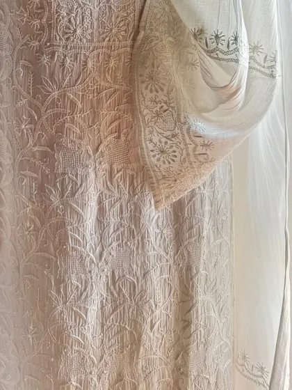 A detail shot focusing on the sleeve and side panel, highlighting the fine 'jaali' work and delicate floral patterns.