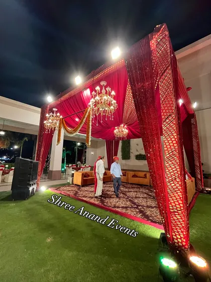 A cozy and regal lounge setup under a red sequined canopy, perfect for VIP guests or family seating.