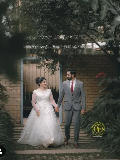 For a timeless and romantic pre-wedding or post-wedding shoot, I offer classic white gowns with intricate details. This look is paired with a sharp grey suit for a perfectly coordinated couple's portrait.