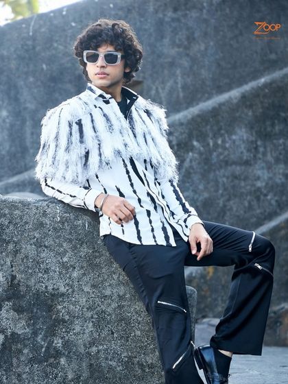 Another angle of our edgy fringe shirt. This piece is crafted from breathable fabric, making it a perfect example of summer sophistication with a rebellious spirit.