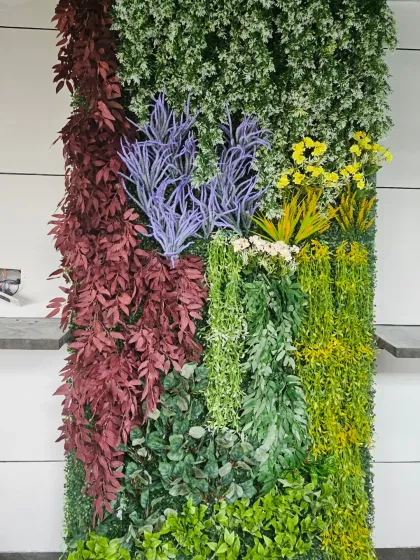 This artificial vertical panel shows a mix of purple, yellow, and red foliage. I use these custom arrangements to add color and break up the monotony of a plain interior or exterior wall.