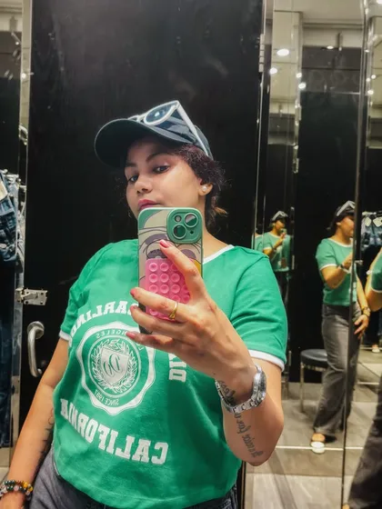 A selfie in a fitting room with interesting mirror reflections, adding an artistic touch to a simple activity.