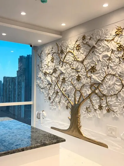 I designed this Kalpavriksh, or Tree of Life, for a high-rise office, with the city skyline as its backdrop. The tree is finished in white with golden branches and flowers, symbolizing prosperity and growth. This sculptural wall art serves as an inspiring and elegant statement piece.