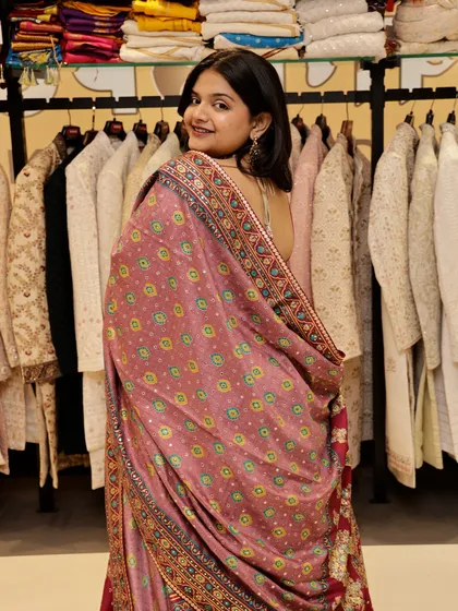 Pretty in pink, powerful in presence. This photo shows the back of a beautiful printed pink lehenga, highlighting the unique dupatta.