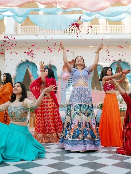 A beautiful flower shower moment during a bridesmaid's performance at a Mehendi. It's a simple touch that adds a lot of beauty and magic to a daytime dance.