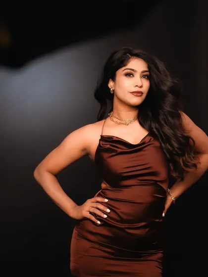A full-body portrait in the studio, showing the model's confident stance. The clean background and focused lighting are ideal for creating professional portfolio images.