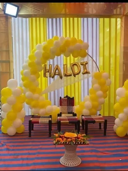 A simple and sweet Haldi setup using a balloon ring and traditional 'charpai' seating. This shows how balloons can also be used beautifully for traditional functions.
