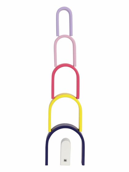 A tower made from stacking the pieces of a wooden pastel arch toy.