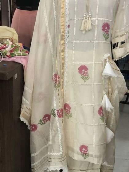 A close-up of the custom suit, highlighting the beautiful block print, lace detailing, and handcrafted tassels on the kurta.