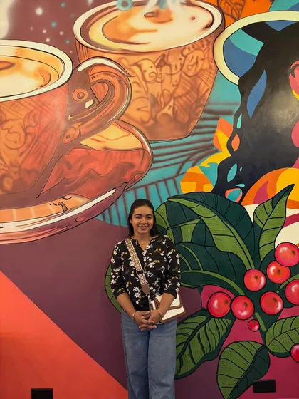Standing proudly in front of my work. This mural was a massive undertaking for a pickleball academy's cafe in Gandhidham.