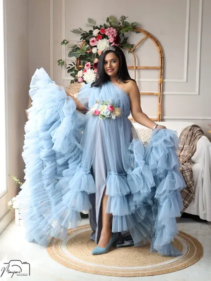 A playful and confident pose, as she shows off the movement of the beautiful blue gown.