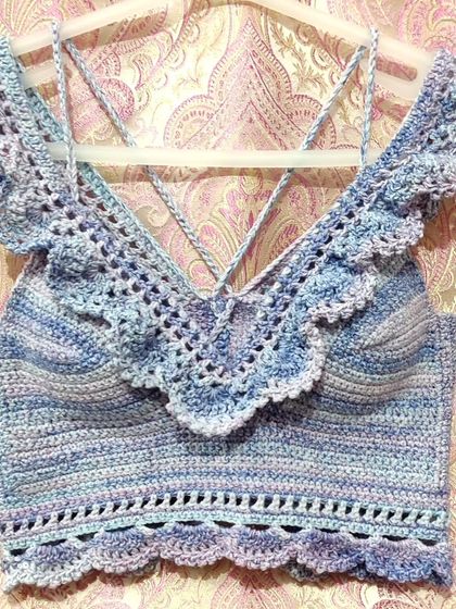 A custom-made 'Masakali' bralette top in a beautiful blue-purple variegated yarn. It features delicate lace details, off-the-shoulder ruffles, and adjustable straps for a perfect, comfortable fit.