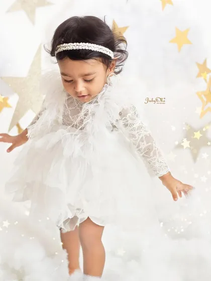 Taking her first steps on the clouds. This candid action shot is so precious and captures a huge milestone.